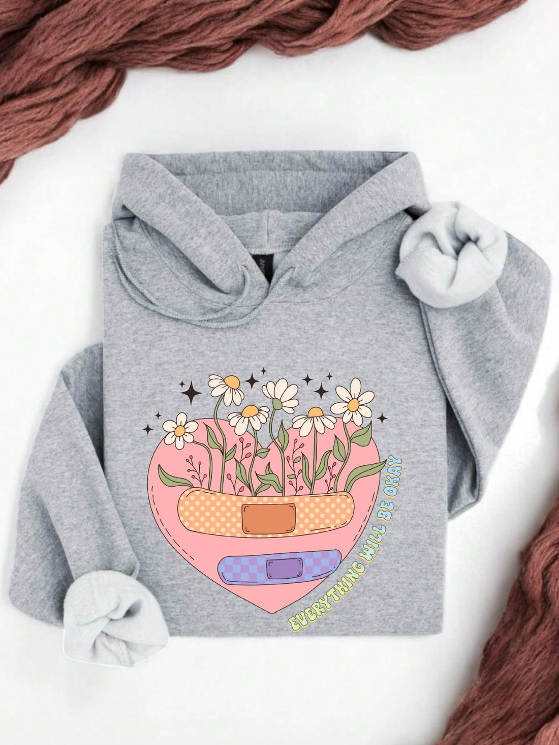 Wrap yourself in comfort and positivity with this playful "Everything Will Be Okay" Floral Heart Hoodie. Featuring a charming floral heart design, it’s perfect for spreading mental health awareness while keeping cozy. Let this hoodie remind you and others that brighter days are ahead, all with a fun and uplifting vibe.