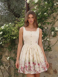 View 1 of ivory floral eyelet button front mini dress with square neckline, wide straps, fitted V waist bodice, back zip, and skater skirt