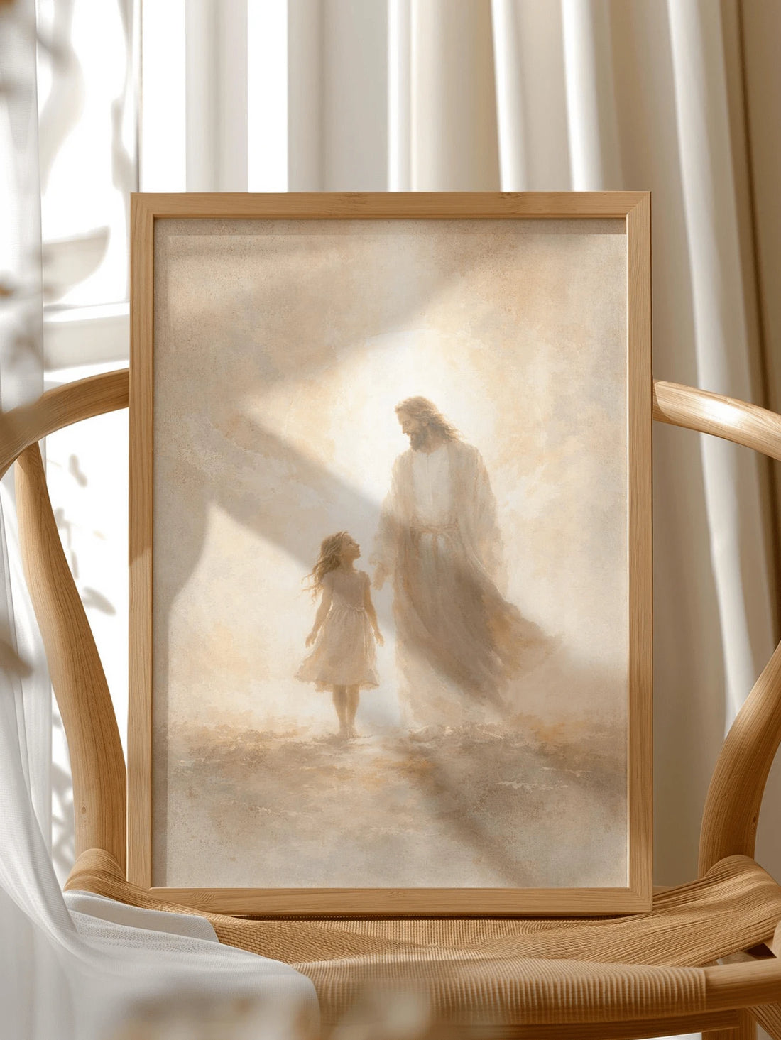 Framed Jesus and little girl canvas art close-up on a light wood chair in a sunlit room