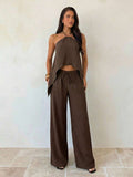 Effortless style meets everyday comfort with this khaki minimalist 2-piece set. The backless camisole features a sleek, modern silhouette perfect for layering or wearing solo, while the loose-fitting long pants provide relaxed movement and a flattering drape. 
