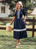 Front view of navy puff-sleeve denim midi dress showing notched neckline and lace skirt band