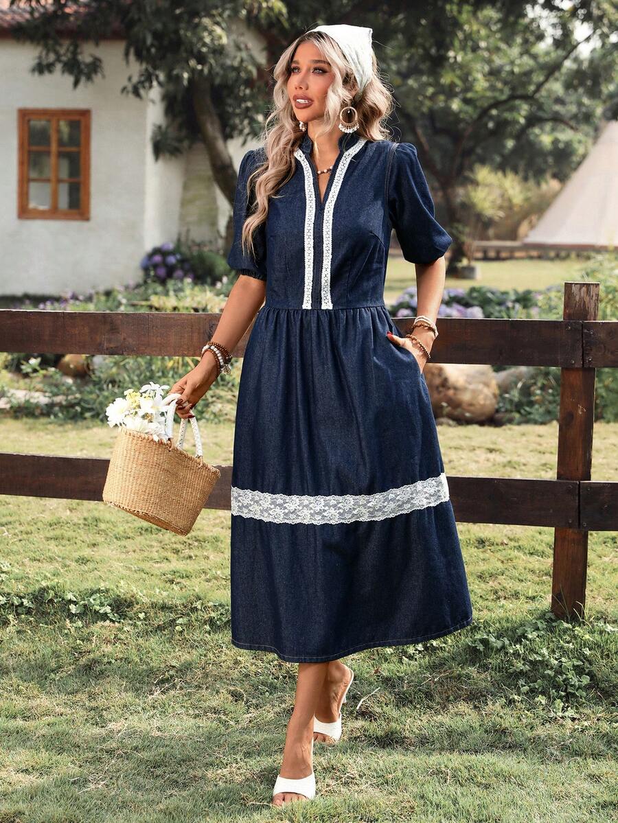 Front view of navy puff-sleeve denim midi dress showing notched neckline and lace skirt band