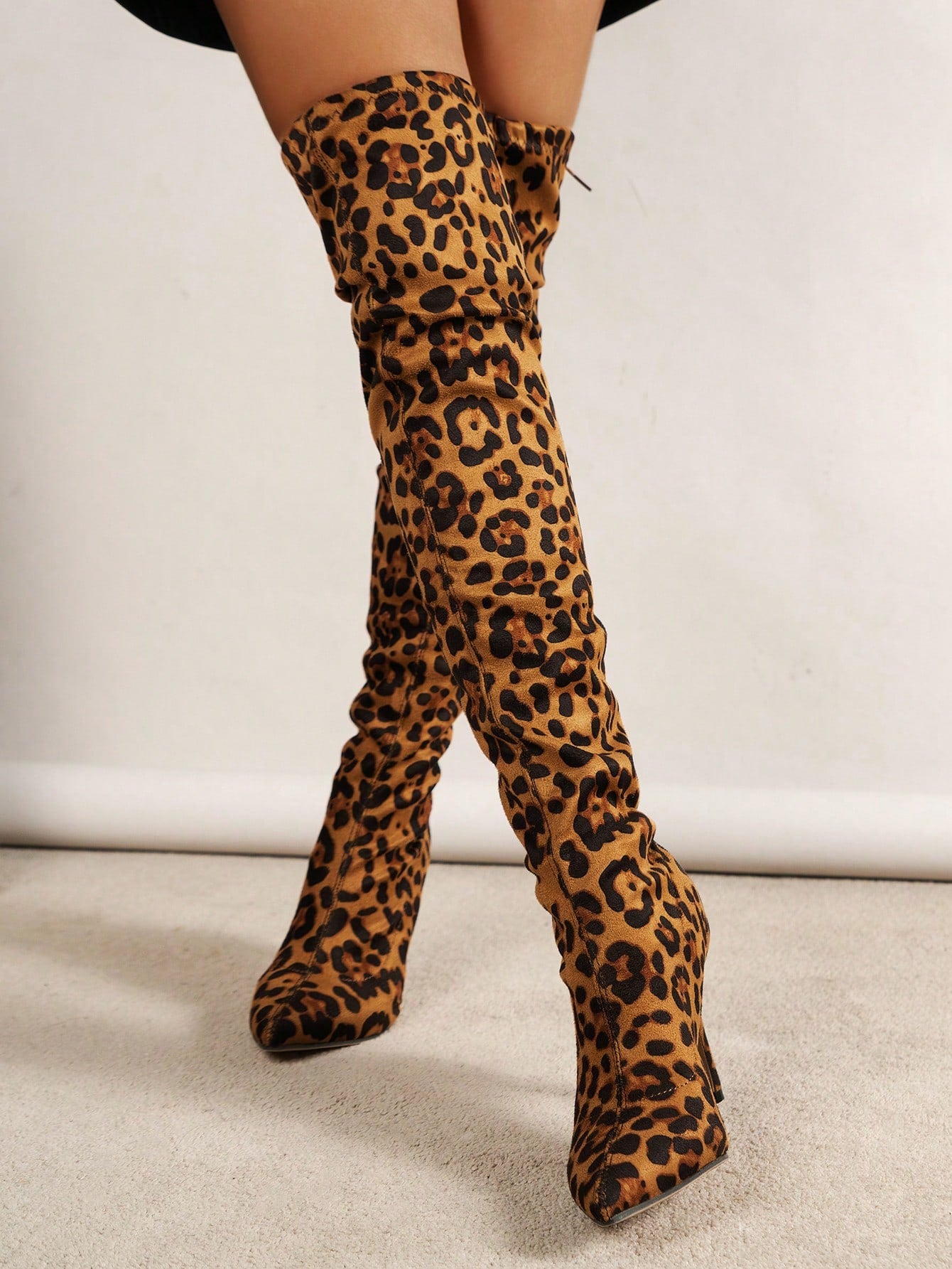 Step out in style this autumn and winter with our Leopard Chic knee-high boots. These sleek, chunky-heeled boots are perfect for any fashionable woman. Let your inner fashionista roam free with our stylish leopard print design. These boots are both functional and trendy, making them a must-have for the cooler seasons.