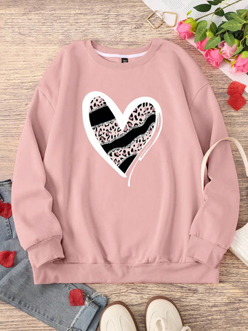 Stay cozy and stylish in our Leopard Heart Print Plus Size Sweatshirt. This fun and quirky top features a playful leopard heart print, a cozy round neck, and long sleeves. Perfect for adding a touch of personality to your wardrobe and staying warm in the cooler months. Available in plus sizes for all body types. Meow!