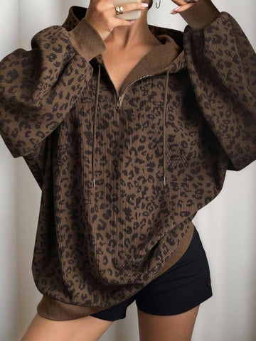 Front worn view of brown leopard-print half-zip hoodie with drawstring hood and rib-knit trim