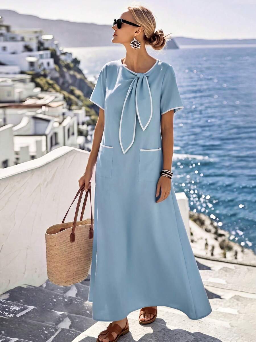 Light blue maxi dress with white-trim bow neck and patch pockets front view