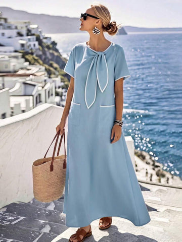 Light blue maxi dress with white-trim bow neck and patch pockets front view