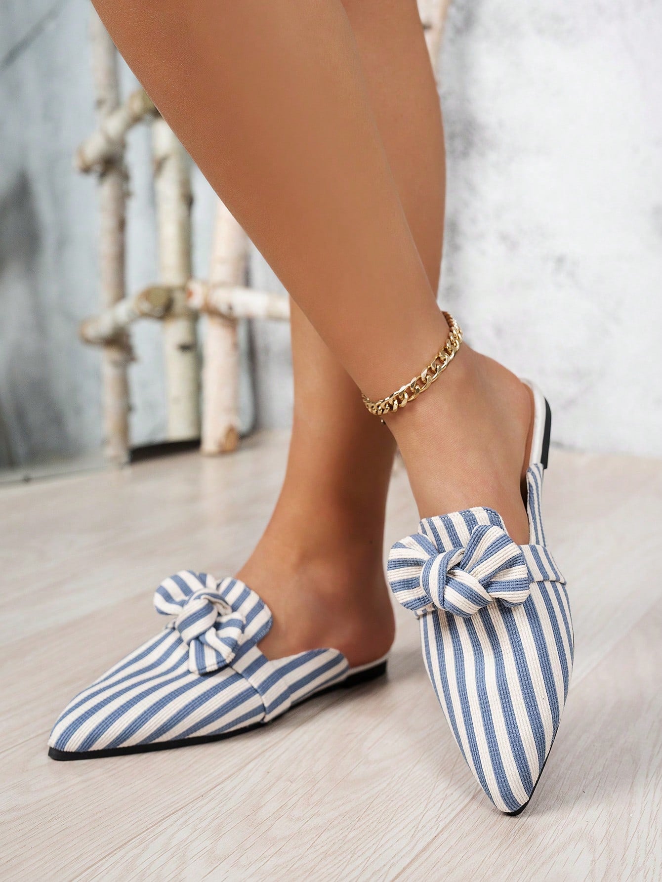 Slip into style with these adorable light blue bowknot mule slippers! The vertical stripes add a fun touch to these comfortable and stylish plus size slippers. Perfect for both indoor and outdoor leisure activities.