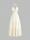Light green halter mini dress with shirred waist and tiered flared hem