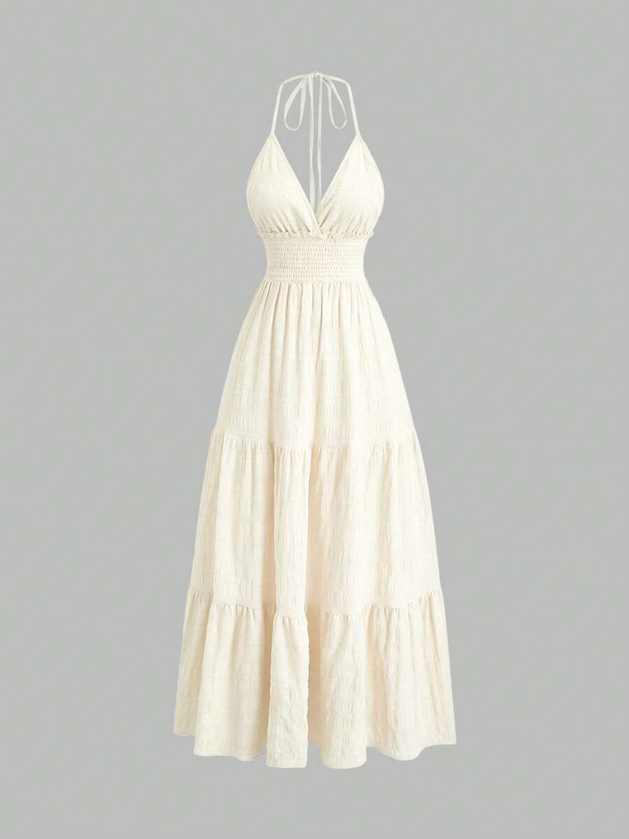 Light green halter mini dress with shirred waist and tiered flared hem