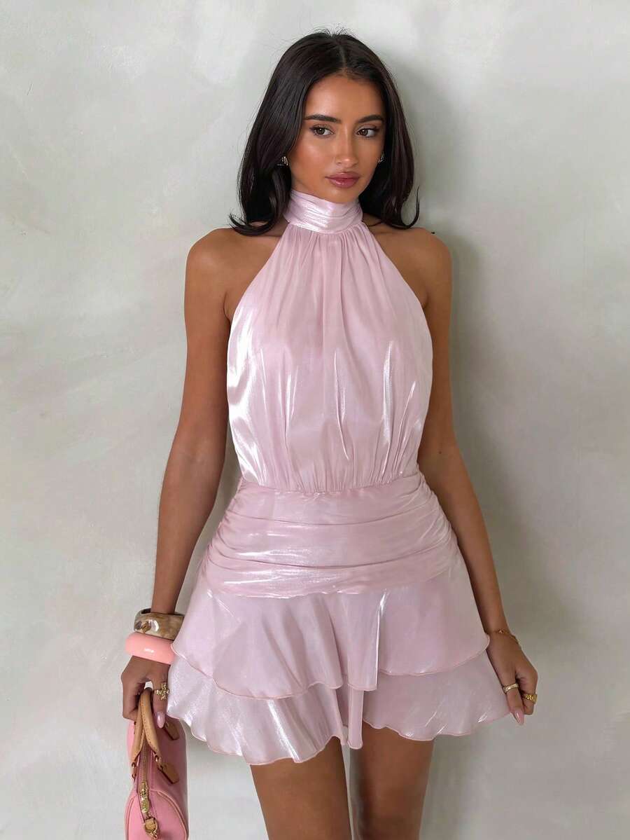 Front view of light pink halter mini dress with gathered waist and tiered ruffle hem
