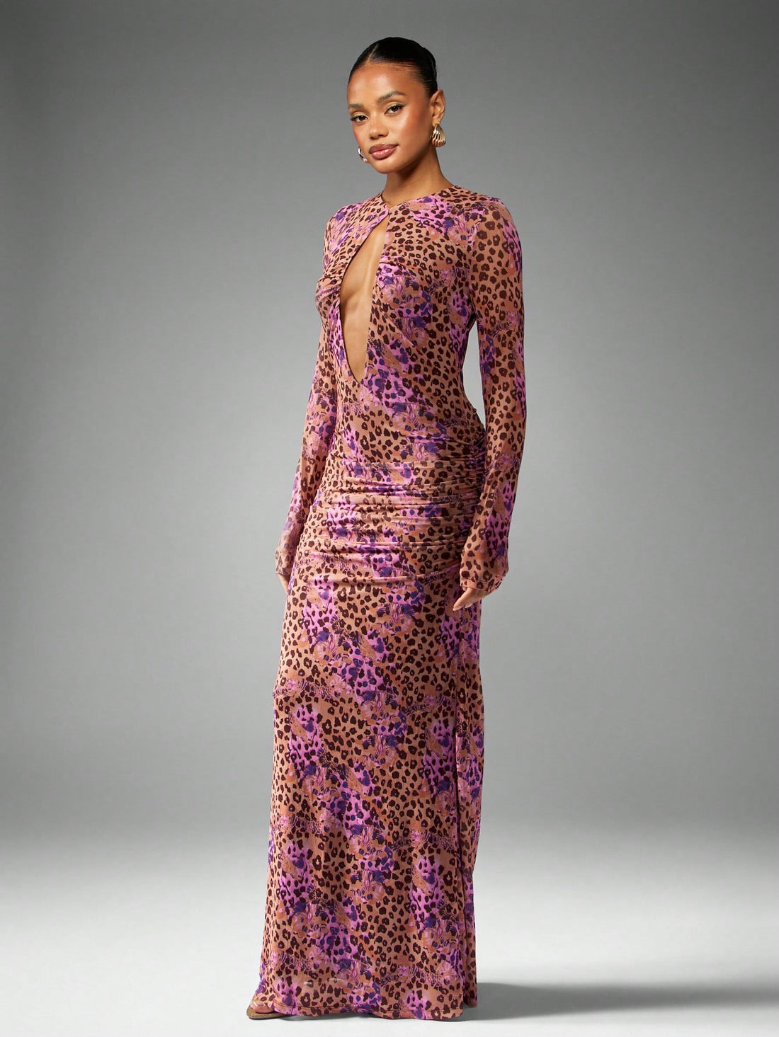 Turn heads at your next event in this stunning leopard print mesh evening gown. The daring plunge neckline and flowing long sleeves create an effortlessly chic silhouette that's equal parts bold and elegant. Sheer mesh detailing adds a touch of allure while the classic leopard pattern ensures you'll stand out from the crowd. Whether you're attending a wedding, gala, or special celebration, this dress delivers the glamour and confidence you need to own the room. A showstopper that proves luxury doesn't have 
