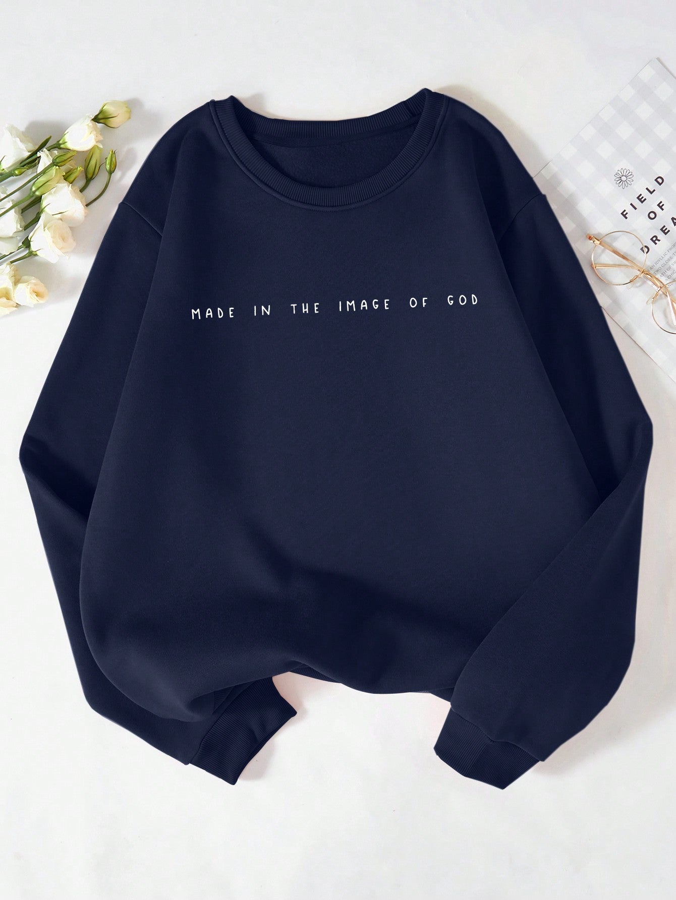 Wrap yourself in inspiration with our Made in the Image of God fleece sweatshirt. Emblazoned with bold, uplifting lettering, this cozy sweatshirt reminds you that you are a unique creation with a divine purpose. Made with soft, high-quality fleece for maximum comfort. Let faith and fashion come together with this one-of-a-kind sweatshirt. Amen.
