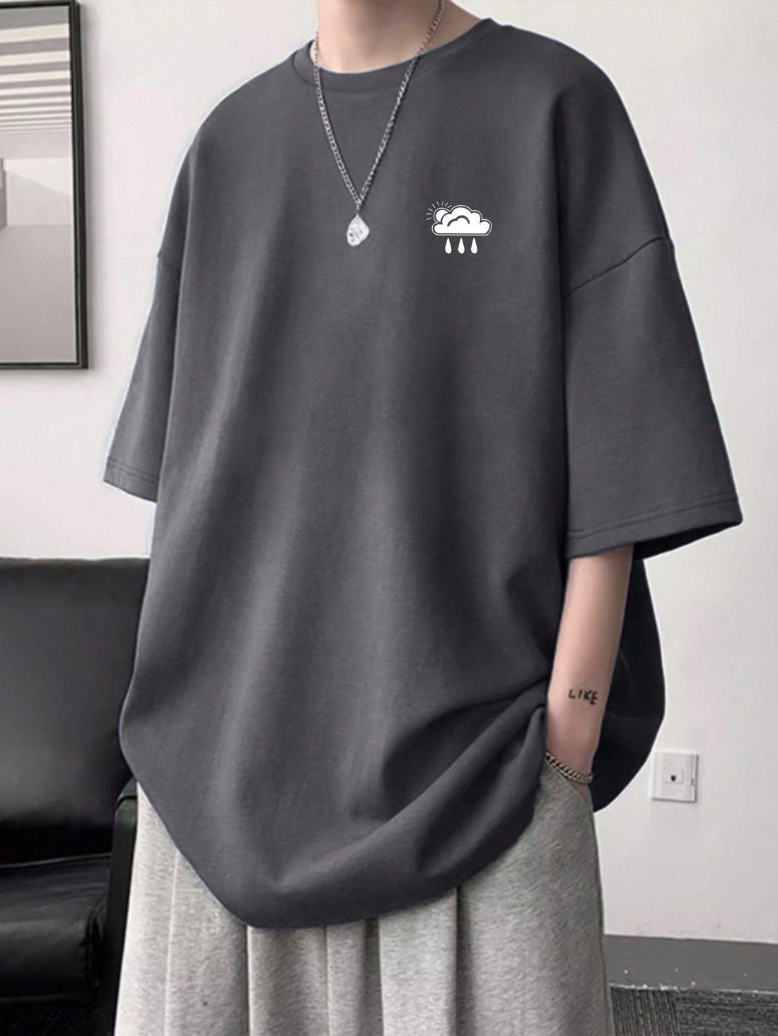 Embrace the playful side of fashion with our Men's Cloud Print T-Shirt. Featuring a trendy drop shoulder design, this casual crew neck tee will have you feeling light as a cloud (and looking stylish too!). Perfect for a fun and carefree look.