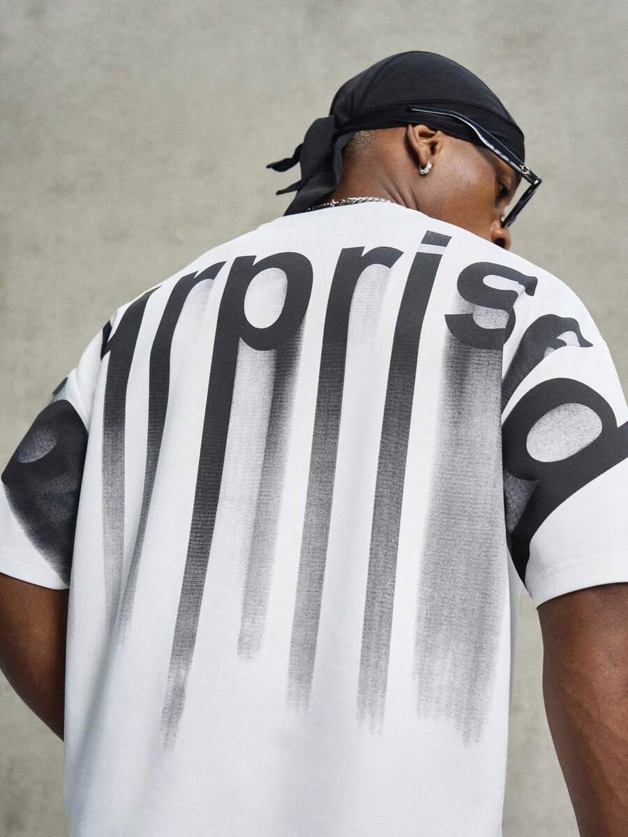 Elevate your casual wardrobe with this men's graphic t-shirt, designed for modern street style. Featuring a bold letter design on the chest, this tee combines contemporary aesthetics with everyday comfort. The classic round neckline and short sleeves offer a versatile fit perfect for layering or wearing solo. Crafted for durability and easy care, it's an essential piece for building a laid-back, fashion-forward look.