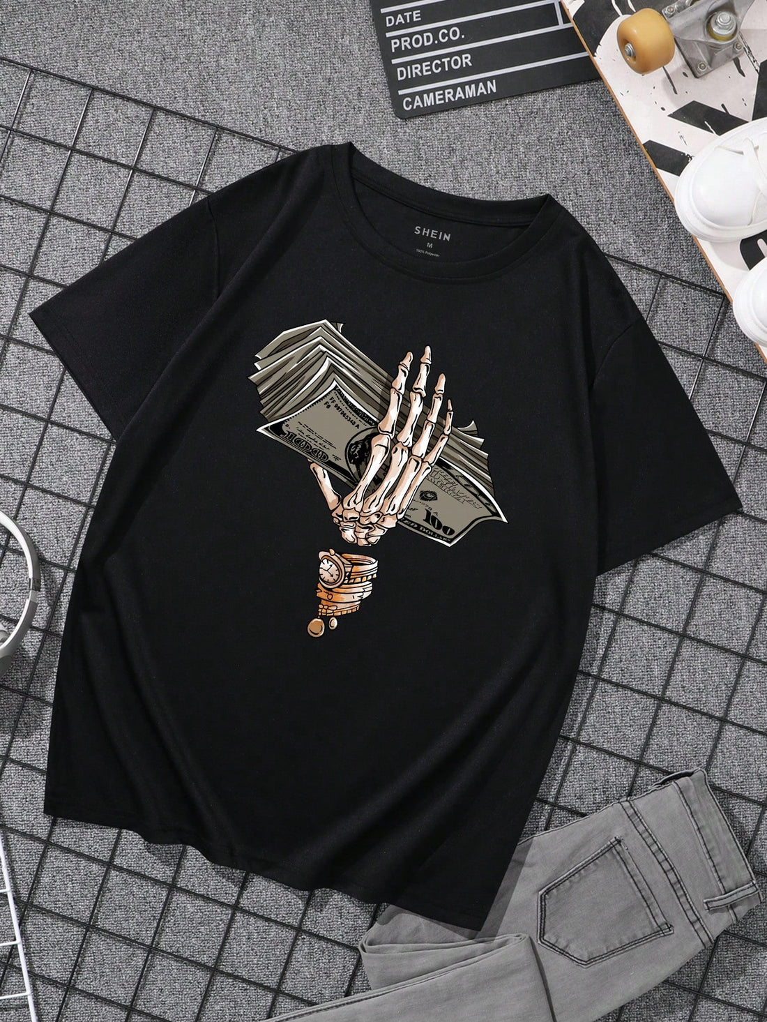 This men's tee features a spooky and unique design of a skeleton hand holding money, perfect for Halloween. Made with high-quality materials, it is comfortable and stylish. Add a touch of novelty to your wardrobe while showing off your love for Halloween.
