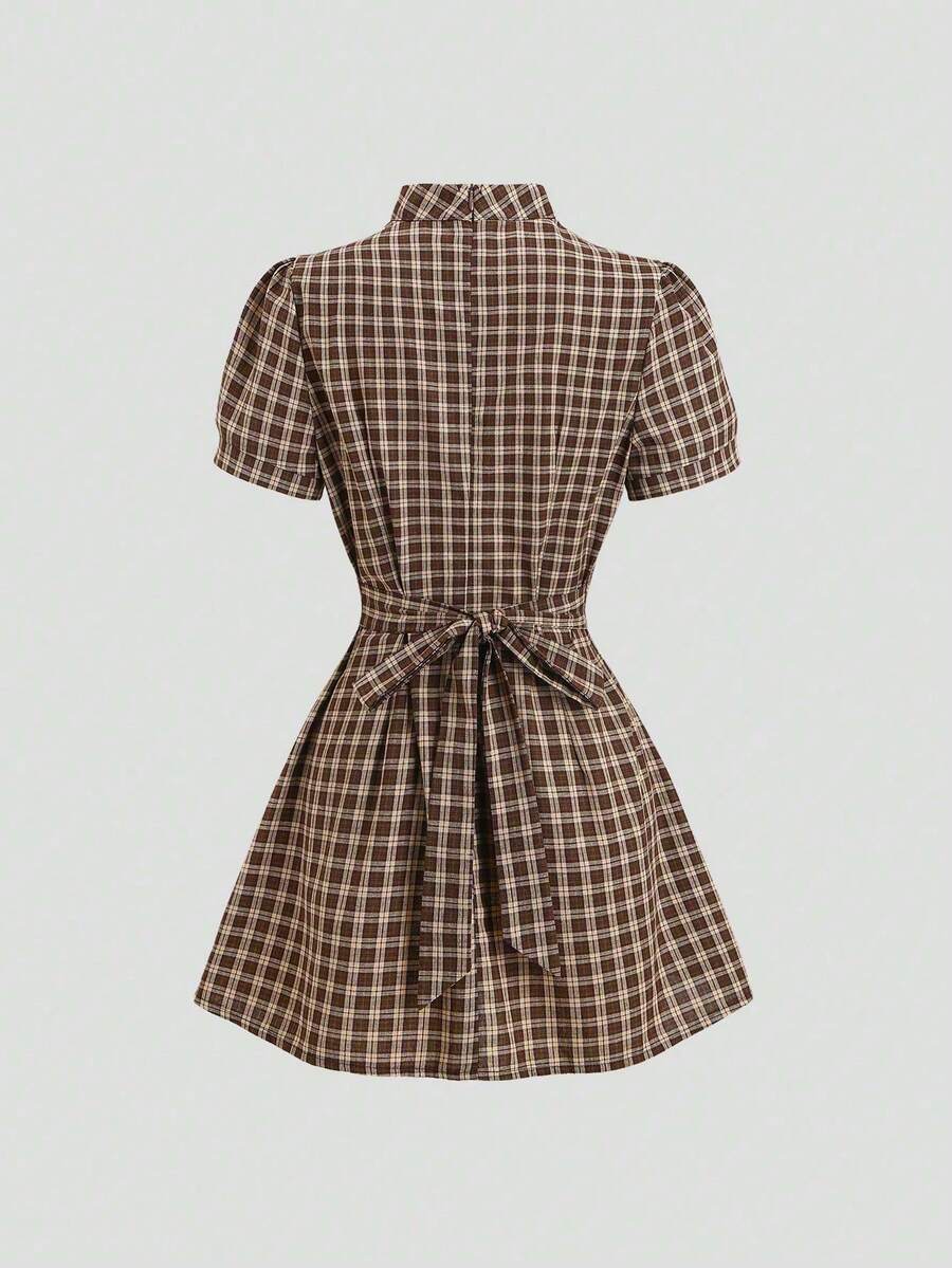 Rear view of brown plaid A-line mini dress with short puff sleeves and tie-back bow