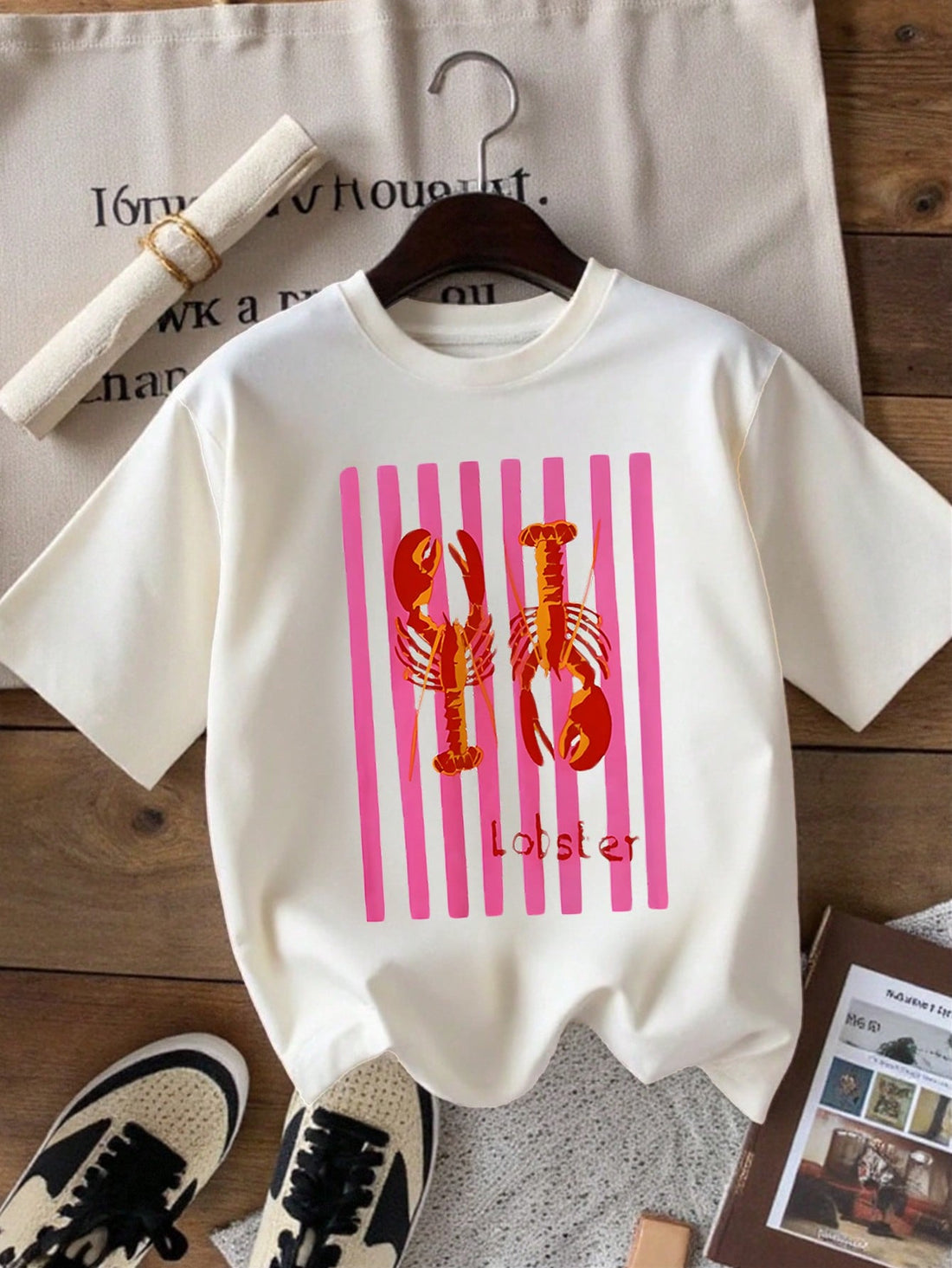 Dive into summer style with this charming minimalist lobster graphic tee. Perfect for casual days, beach trips, or whenever you want to add a splash of personality to your wardrobe. The clean, understated design keeps things cool and collected while the playful lobster motif brings a touch of whimsy. Crafted for comfort and everyday wear, this women's tee pairs effortlessly with shorts, jeans, or your favorite summer skirt. A fun conversation starter that doesn't take itself too seriously.