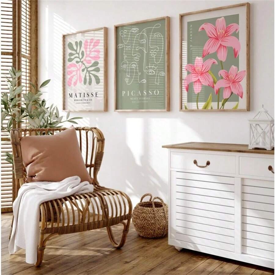 Set of three framed abstract botanical canvas prints with olive green, pink and cream artwork in a sunlit room