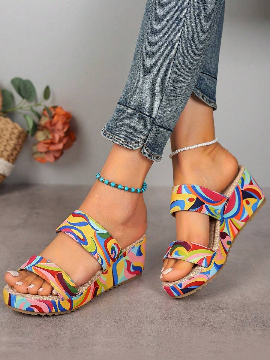 Multicolor swirl wedge slide sandals on foot front side view with open toe and wide straps