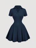 Front view of navy blue rib-knit polo mini dress with flared A-line hem