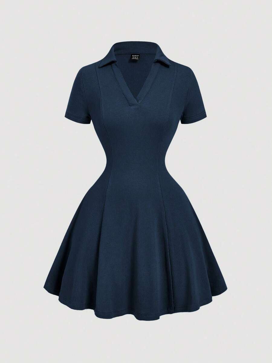 Front view of navy blue rib-knit polo mini dress with flared A-line hem