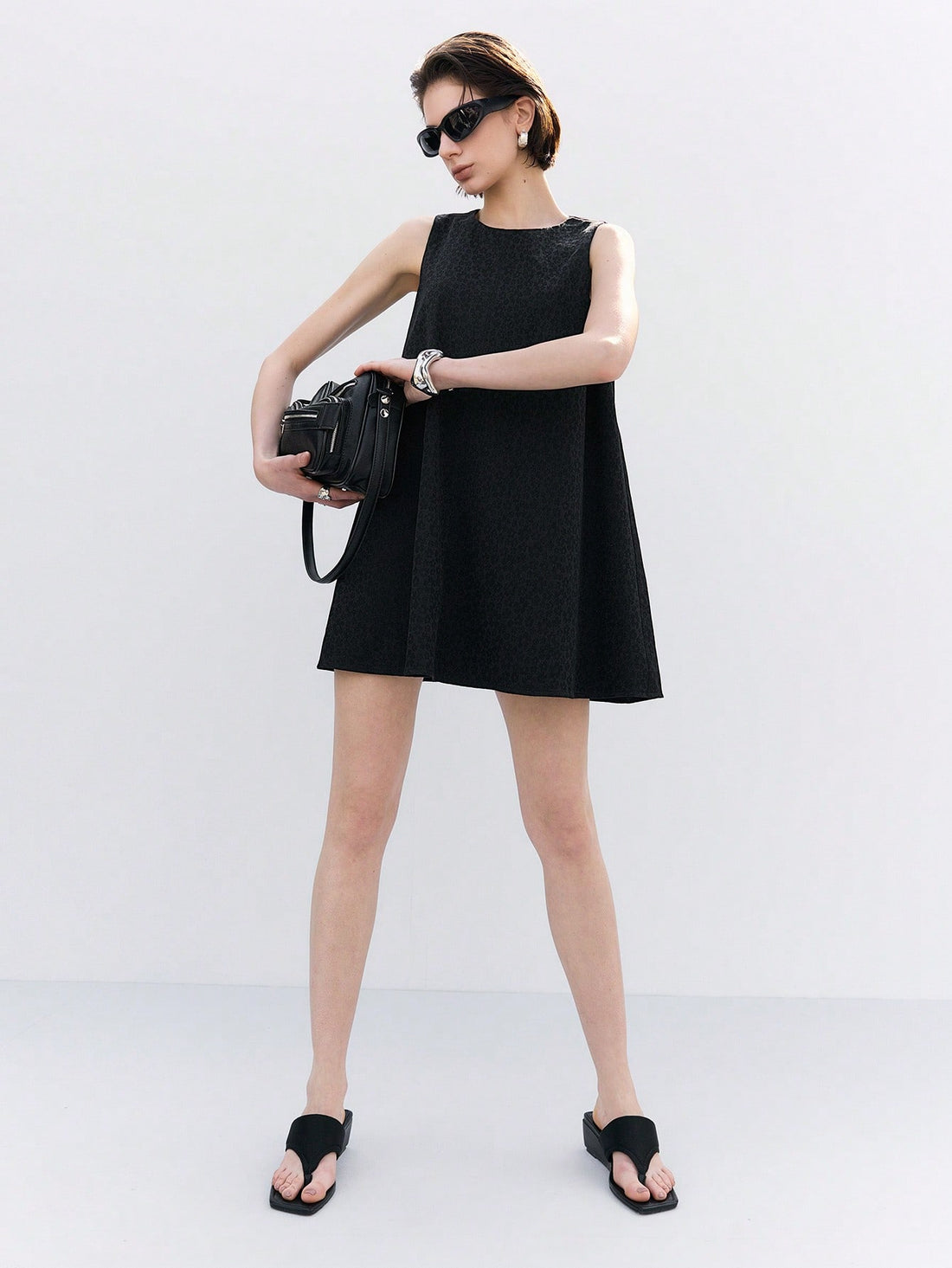 Step out in style with this playful sleeveless A-line mini dress crafted from textured jacquard fabric. Its casual round neckline adds a touch of effortless charm, making it perfect for sunny days or fun nights out. Flattering and comfortable, this dress brings a fresh, flirty vibe to your wardrobe.