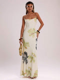 Elevate your warm-weather wardrobe with this stunning ombre gradient cami dress. Featuring a flattering backless design with criss-cross lace-up detailing and delicate spaghetti straps, this maxi dress combines elegance with effortless style. The all-over botanical print and slim-fit silhouette create a graceful mermaid hem that flows beautifully. Crafted from a high-stretch knit blend of polyester and elastane, it offers comfort and flexibility for all-day wear. Perfect for beach getaways, casual outings, 