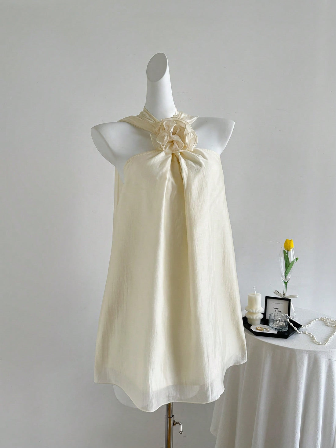 Turn heads with the Parisian Petal Slip Dress, featuring a flirty halter neck and open shoulders that highlight your natural charm. Delicate floral embellishments add a romantic touch, making it perfect for date nights or special occasions. This dress combines sexy elegance with playful style for a look that’s effortlessly captivating.