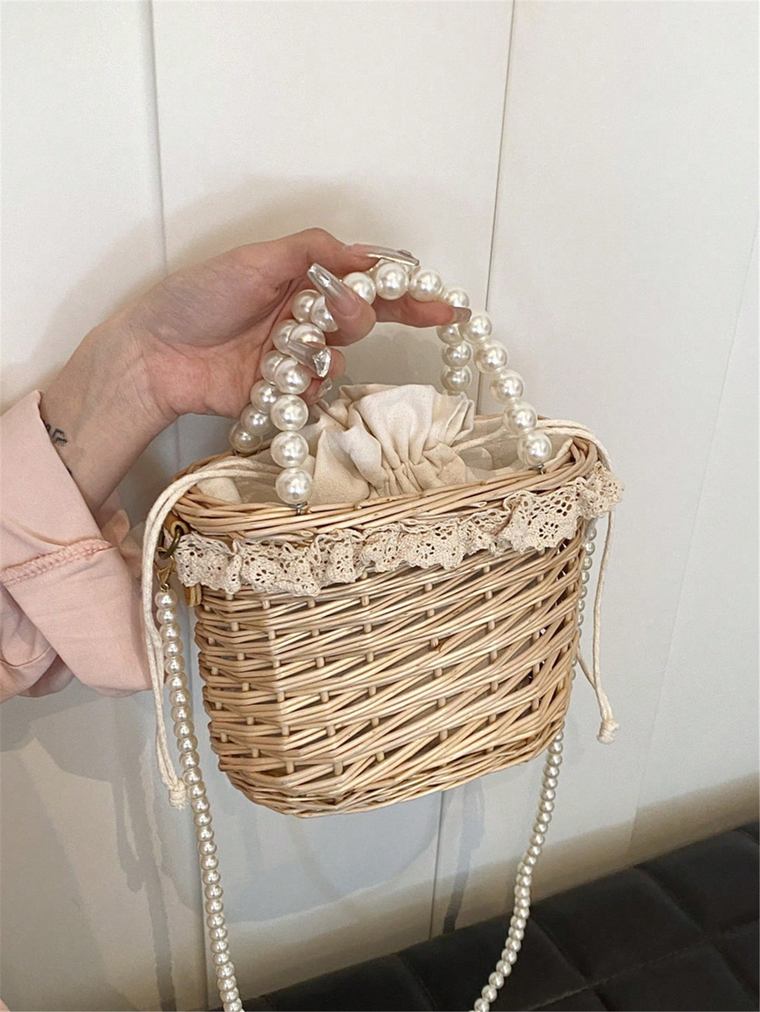 This handmade wicker bag is adorned with delicate pearls, making it the perfect crossbody souvenir. Its intricate design and sturdy construction make it a stylish and practical choice. With its unique combination of beauty and functionality, it's an ideal accessory for any occasion.