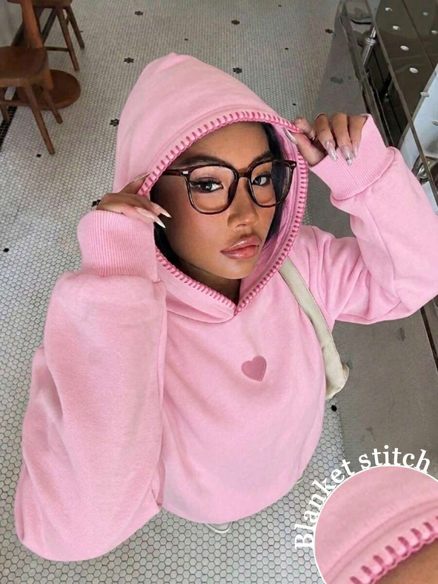 Add a playful touch to your wardrobe with this Pink Knit Hoodie Sweatshirt for Women, featuring a charming heart patch and trendy Y2K-inspired design. Crafted from soft knit fabric, this cozy pullover offers lightweight warmth and lasting comfort for everyday wear. The relaxed fit and attached hood create an effortlessly stylish look that's perfect for pairing with jeans, leggings, cargo pants, or skirts.