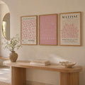 Three-piece pink Matisse and Picasso canvas art set above a warm entry console