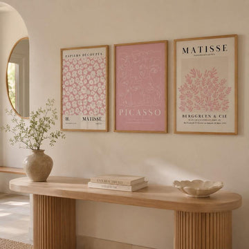 Three-piece pink Matisse and Picasso canvas art set above a warm entry console