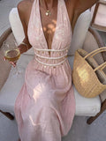 Close front view of pink halter maxi dress with embroidered bodice and shell trim