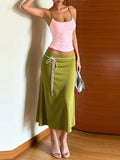 Front view of pink spaghetti-strap cami and olive flared maxi skirt two-piece set with contrast waist tie