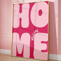 Pink Welcome Home bubble-letter canvas art leaning against a pink paneled wall