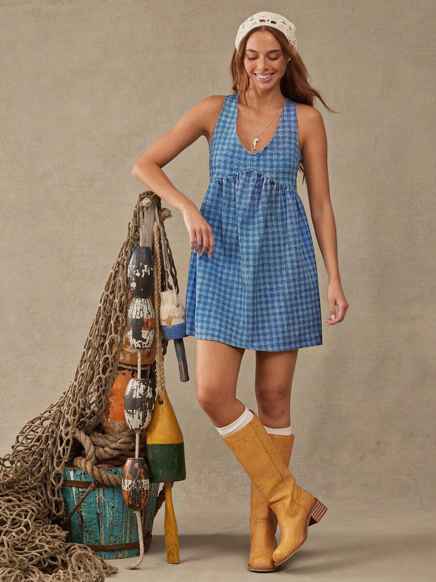Front view of blue plaid denim babydoll mini dress with flared skirt for casual styling