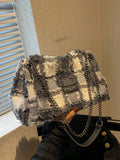 The Plaid Perfection large handbag with chain strap is the ultimate tote bag for women. Its stylish plaid design and sturdy chain strap make it the perfect accessory for any outfit. With its spacious size and durable construction, you can easily carry all your essentials while looking chic. Elevate your wardrobe with this must-have accessory.