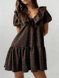 Front view of coffee plaid mini dress with ruffle collar and puff sleeves
