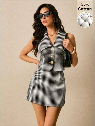 Front three-quarter view of black-and-white gingham vest and A-line mini skirt set with gold buttons