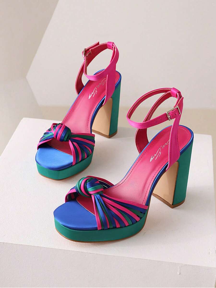 Multicolor platform block heel sandals with pink ankle straps on white pedestal