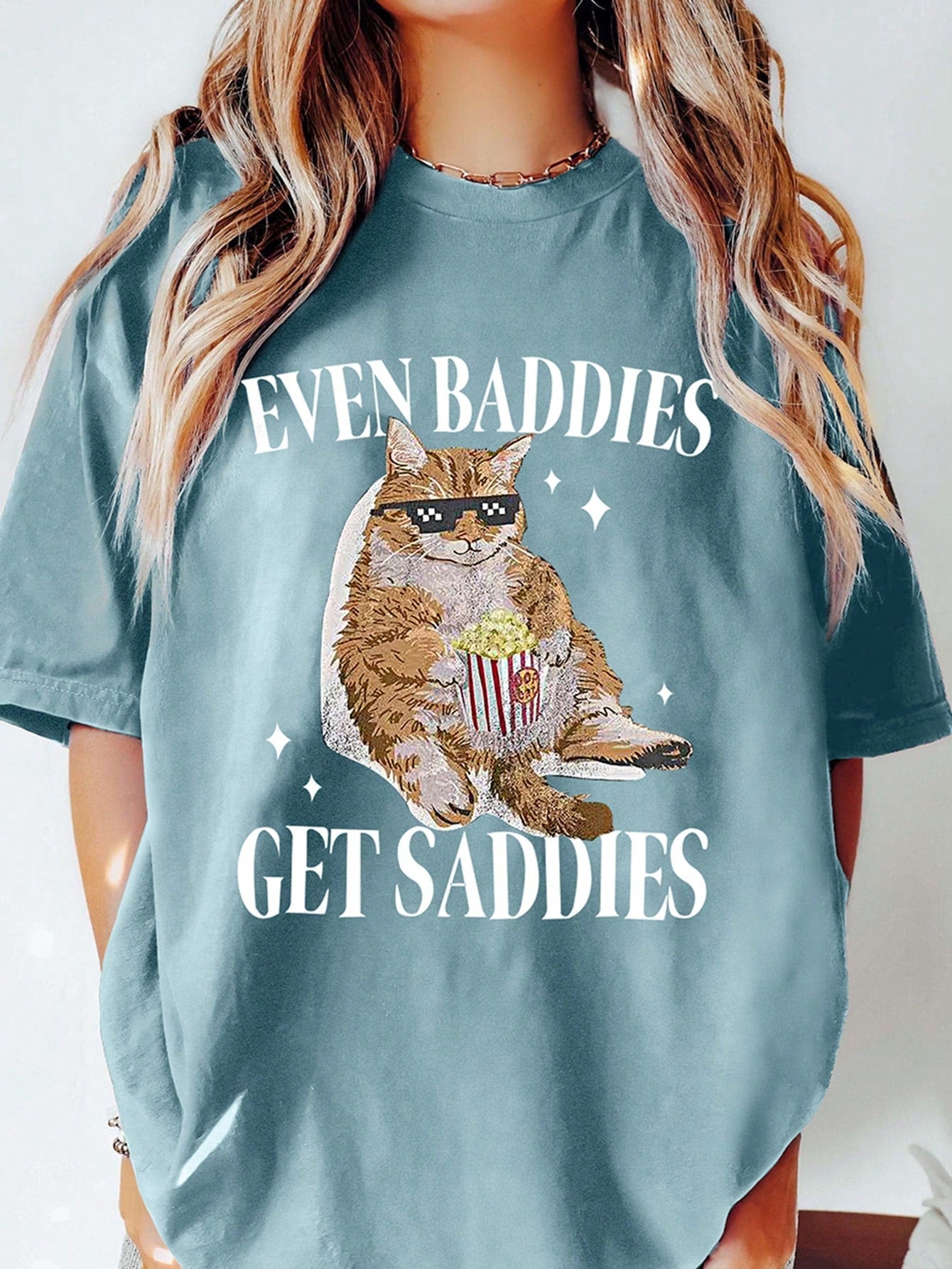 This tee is perfect for the fun-loving and quirky cat ladies out there! The playful cat and letter print adds a touch of humor to any outfit. The loose fit is perfect for staying cool during the summer. Express your unique style with this tee!
