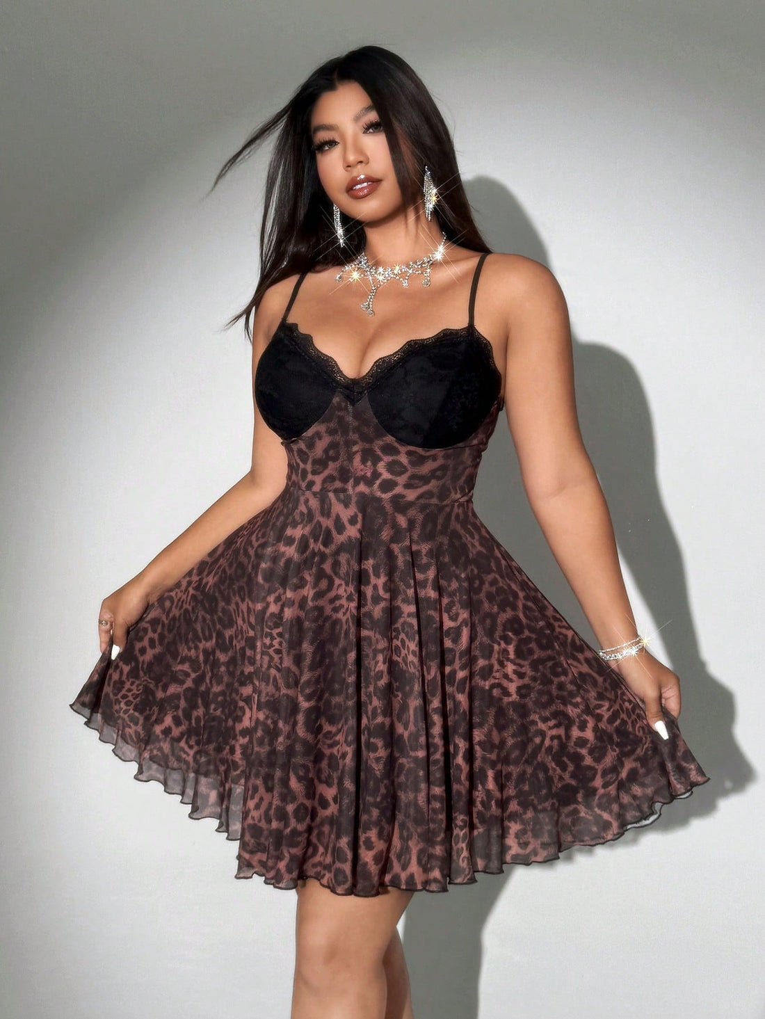 Turn heads with this playful plus-size lace dress featuring a bold leopard print and delicate spaghetti straps. The cinched waist flatters your figure, creating a fun and flirty silhouette perfect for any occasion. Embrace your wild side with style and confidence!