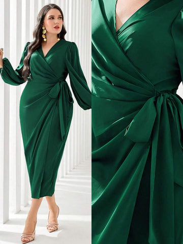 Make a statement in this stunning plus-size wrap dress that's equal parts sophisticated and fun. The dramatic lantern sleeves add movement and flair, while the flattering side knot detail cinches your waist beautifully. Perfect for evening events, galas, or any occasion where you want to feel absolutely fabulous. The flowing silhouette skims your curves in all the right ways, giving you confidence and comfort. Dress it up with heels and jewelry, or keep it effortlessly chic—this gown adapts to your style an