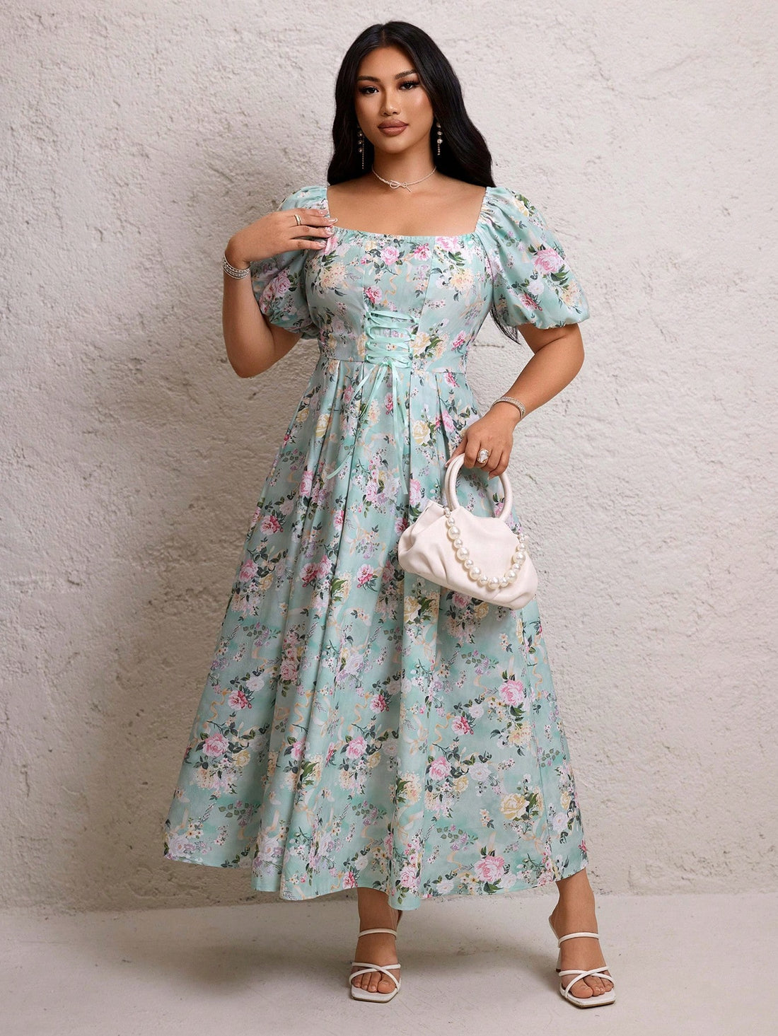 This plus size A-line dress brings fun and flair to your wardrobe with its eye-catching graphic print and playful diamond square neckline. The short sleeves keep it breezy, while the adjustable drawstring detail lets you customize the fit for comfort and style. Perfect for sunny days or casual outings, this dress combines charm and ease in one delightful package.