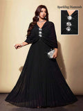 Shop a plus size black chiffon pleated dress with rhinestone accents. Perfect for parties, weddings, cocktail events, dinners, holidays, and special occasions.