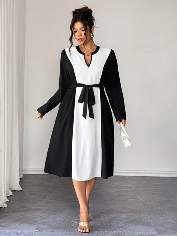 Elevate your wardrobe with this stunning plus-size dress that's equal parts chic and comfortable. The classic black and white palette pairs beautifully with the flattering V-neckline and long sleeves for a polished look that works from office to dinner. The tie waist cinches in all the right places, creating a gorgeous silhouette while the elegant design keeps you feeling confident and fabulous. Perfect for anyone who refuses to compromise on style or fit.