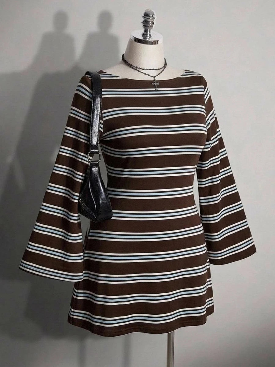 Front view of brown striped knit mini dress on mannequin with long flared sleeves and shoulder bag