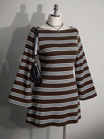 Front view of brown striped knit mini dress on mannequin with long flared sleeves and shoulder bag