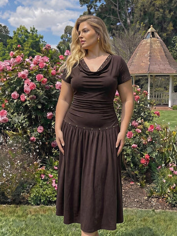 Front view of dark brown cowl-neck midi dress with gold-tone ring detail and flared skirt